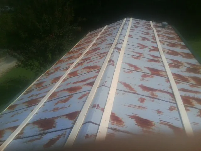 Rusted metal roof panels with new wood purlins before replacement — Storm Damage Roof Repair in Immaculata by Roofing Brothers
